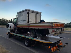 folami towing truck moving a vehicle