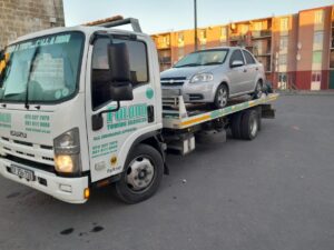 folami towing truck moving a grey car