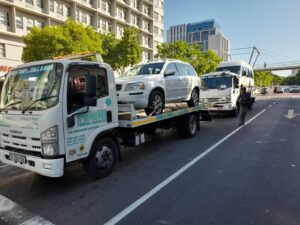 two folami towing trucks moving vehicles
