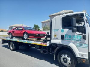 folami truck pulling a red porsche