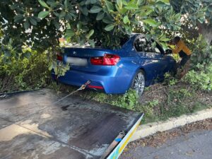 pulling out a stuck blue bmw