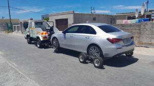 folami towing truck pulling a mercedes-benz